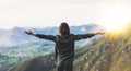 Happy tourist traveler stand on a rock with raised hands, hiker looking to a valley below in trip in spain, hipster young girl Royalty Free Stock Photo