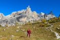 Happy tourist trekker girl in Dolomites mountains in autumn