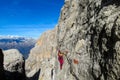 Happy tourist trekker girl in Dolomites mountains via ferrata