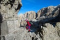 Happy tourist trekker girl in Dolomites mountains via ferrata Royalty Free Stock Photo