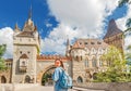 Tourist woman with backpack posing on bridge in front of Vajdahunyad castle in Budapest, Hungary Royalty Free Stock Photo