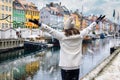 A happy tourist woman enjoys the view to the beautiful Nyhavn area in Copenhagen Royalty Free Stock Photo