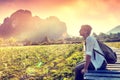 Happy tourist woman meets a sunset overlooking the mountains and Royalty Free Stock Photo