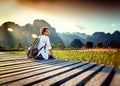 Happy tourist woman meets a sunset overlooking the mountains and Royalty Free Stock Photo