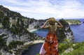 Happy Tourist woman in red dress enjoys her tropical beach Royalty Free Stock Photo