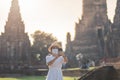 Happy tourist woman wearing surgical face mask and taking Photo by mobile smartphone, protection COVID-19 pandemic during visiting Royalty Free Stock Photo