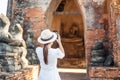 Happy tourist woman in white dress taking Photo by mobile smartphone, during visiting in Wat Chaiwatthanaram temple in Ayutthaya Royalty Free Stock Photo