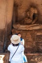 Happy tourist woman in white dress taking Photo by mobile smartphone, during visiting in Wat Chaiwatthanaram temple in Ayutthaya Royalty Free Stock Photo