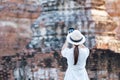 Happy tourist woman in white dress taking Photo by mobile smartphone, during visiting in Wat Chaiwatthanaram temple in Ayutthaya Royalty Free Stock Photo