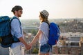 Happy tourists couple, friends sightseeing city with map together. Travel people concept. Royalty Free Stock Photo