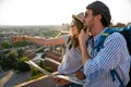 Happy tourists couple, friends sightseeing city with map together. Travel people concept. Royalty Free Stock Photo