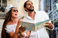 Happy tourists couple in love sightseeing city with map during summer vacation Royalty Free Stock Photo