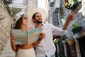 Happy tourists couple in love sightseeing city with map during summer vacation Royalty Free Stock Photo