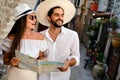 Happy tourists couple in love sightseeing city with map during summer vacation Royalty Free Stock Photo