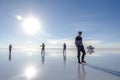 Happy tourists enjoy Jeep tour activities in Salt flat Lake Salar de Uyuni in Bolivia