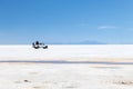 Happy tourists enjoy Jeep tour activities in Salt flats Salar de Uyuni in Bolivia