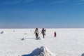 Happy tourists enjoy Jeep tour activities in Salt flats Salar de Uyuni in Bolivia