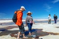 Happy tourists enjoy Jeep tour activities in Salt flats Salar de Uyuni in Bolivia