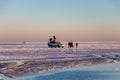 Happy tourists enjoy Sunset during four wheel tour in Salt flat Lake Salar de Uyuni in Bolivia