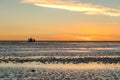 Happy tourists enjoy Sunset during four wheel tour in Salt flat Lake Salar de Uyuni in Bolivia