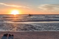 Happy tourists enjoy Sunset during four wheel tour in Salt flat Lake Salar de Uyuni in Bolivia