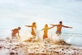 Happy tourists run sea sunset beach Royalty Free Stock Photo