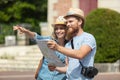 Happy tourists sightseeing city with map Royalty Free Stock Photo