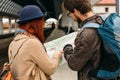 Happy tourists sightseeing city with map on train station before walking or travelling. Royalty Free Stock Photo