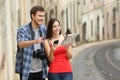 Happy tourists sightseeing in an old town street