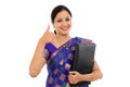 Happy traditional woman holding folder against white