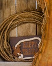 Happy trails wood shelf with rope & chaps Royalty Free Stock Photo