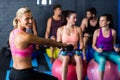 Happy trainer with athletes in gym Royalty Free Stock Photo