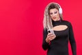 Happy transgender person listening music with headphones and a mobile