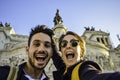 Happy travel couple taking selfie with the smartphone in famous landmark in la Piazza Venezia, Rome, Italy Royalty Free Stock Photo