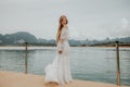 Happy Travel Girl Fun on Wooden Pier with Lake, Rainforest Jungle and Mountains