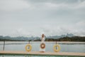 Happy Travel Girl Fun on Wooden Pier with Lake, Rainforest Jungle and Mountains