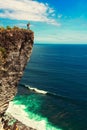 Travel man standing on the top mountain cliff on background nature landscape