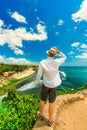 Happy travel man with hat enjoying summer vacation on tropical island Bali and enjoy amazing top view tropical Balangan beach Royalty Free Stock Photo