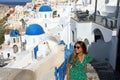 Happy travel tourist woman go upstairs in Santorini, Greek Islands, Greece, Europe. Girl on summer vacation visiting famous Royalty Free Stock Photo