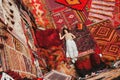 Happy travel woman with amazing colorful carpets in Local carpet shop ,Goreme. Cappadocia Turkey