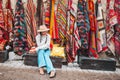 Old traditional Turkish carpet shop in cave house Cappadocia, Turkey Kapadokya. Young woman on vacation in Turkey Royalty Free Stock Photo