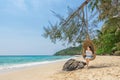 Happy traveler Asian woman relaxing on luxury swing and looking beautiful nature landscape beach. summer holiday vacation travel Royalty Free Stock Photo