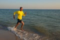 Happy traveler, delighted, is running along the surf line Royalty Free Stock Photo