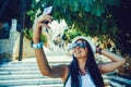 Happy traveler girl taking selfie photo on phone on Greek island of Symi, Dodecanese, Greece Royalty Free Stock Photo