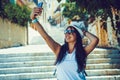 Happy traveler girl taking selfie photo on phone on Greek island of Symi, Dodecanese, Greece Royalty Free Stock Photo