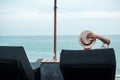 Happy traveler man with hat enjoy beautiful sea view, young man sitting on chair at sand beach. Freedom, relaxing, vacation Royalty Free Stock Photo