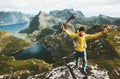 Happy traveler man success raised hands standing on mountain top Royalty Free Stock Photo