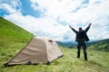 Happy traveler in the mountains near the tent Royalty Free Stock Photo