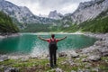 Happy traveler standing and admiring Dachstein peak mountains on a Upper Gosau Lake. Gosau, Salzkammergut, Austria Royalty Free Stock Photo