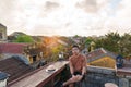 Happy traveler traveling at Hoi An ancient town in Vietnam, man sightseeing view at rooftop. landmark and popular for tourist Royalty Free Stock Photo